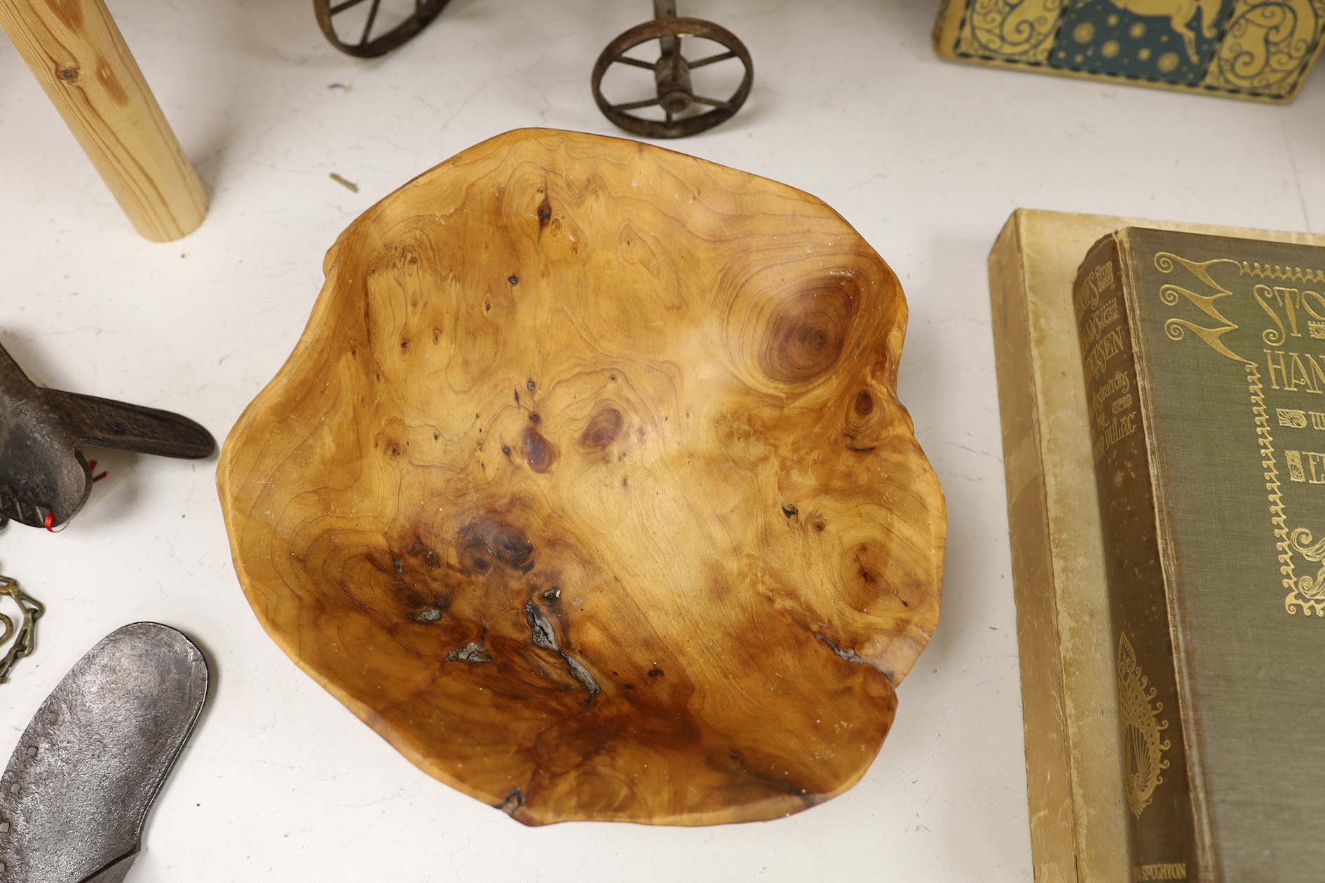 A cast iron toy model of a tricycle, a carved wooden bow, a classical figurative door knocker, a pair of metal cow shoes and two ceramic cistern pulls, bowl 30cm diameter. Condition - fair